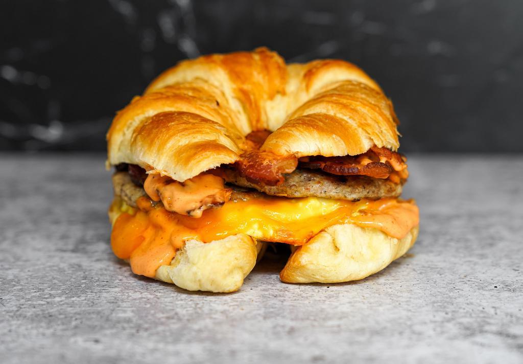 Big Breakfast Croissant · 2 scrambled eggs, melted Cheddar cheese, bacon, breakfast sausage, grilled onions  and Sriracha aioli on a warm croissant