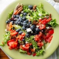 Wild Blueberry Salad · Mixed greens, blueberries, candied pecans, tomatoes, and goat cheese with blueberry vinaigre...