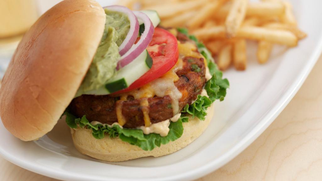 Southwestern Veggie Burger · Made with black beans and topped with cucumber, avocado, Cheddar Jack cheese, chipotle aioli, lettuce, tomato and pickle; served on a brioche bun. High in protein, all natural, low fat and low sodium.