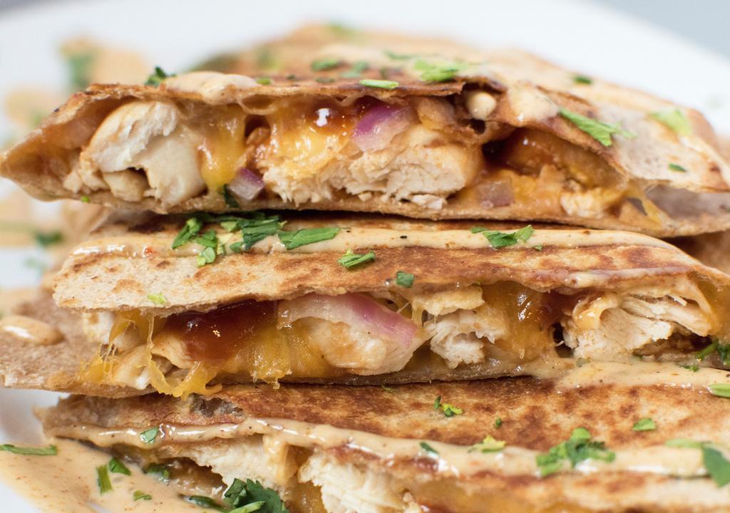 Barbecue Chicken · Grilled chicken, Sweet BBQ sauce, red onions, fresh cilantro and Cheddar Jack in a whole wheat tortilla. Topped with chipotle ranch and minced celery.