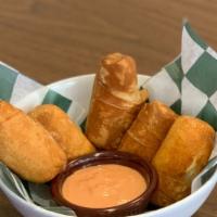 Minitequeños (5 Uds) · Small cheese sticks with pink sauce.