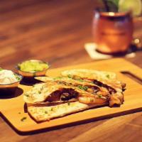 Chicken Quesadilla · Flour tortilla, chicken, four cheese mix, served with sour cream, and guacamole.
