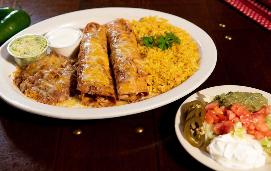  Flautas Rancheras · Flour tortilla fried filled your choice of either ground beef, shreeded beef or chicken, rolled like a flaute, golden fried till crispy and smoothered with melted cheese.