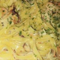 Chicken & Shrimp Pasta With Garlic Toast · Grilled chicken and shrimp over fettuccine noodles tossed in creamy alfredo parmesan sauce o...