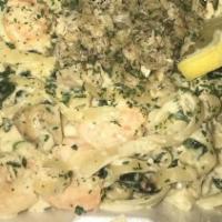 Foster'S Ultimate Crab Pasta · crab meat, chicken, sausage, shrimp and spinach over fettuccine noodles tossed in a creamy a...