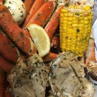 Crab Platter · Two snow crab leg clusters, two sweet corn, four potatoes, two Cajun sausages, chicken, pork...