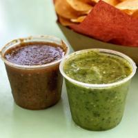 Salsa & Chips · House red and green salsas.