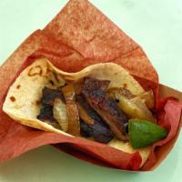 Steak Al Carbon Taco · Beef fajita, smoked onions, and pico
