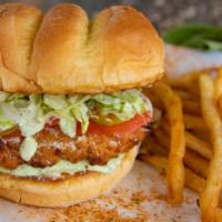 Pesto Chicken Sandwich · A crispy breaded and baked chicken breast with melty Swiss cheese, aged parmesan, sliced tom...