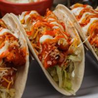 Buffalo Chicken Tacos Duo · Crispy breaded and baked chicken breast tossed in our Medium Buffalo sauce, sitting atop shr...