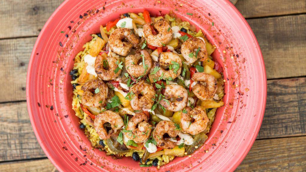 Caribbean Shrimp · We start with a huge bed of our flavorful Reggae Rice and top it with a mix of sautéed red and green peppers, grilled onions and sweet, juicy pineapple. Then the voodoo kicks in with a drizzle of our Magic Jerk sauce and our delicious jerk shrimp.