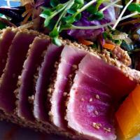 Seared Tuna Salad · Lightly seared tuna on a field of greens with avocado, wakame and sesame seeds served with h...