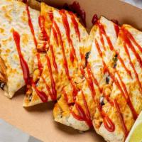 Quesadilla · Your choice of protein, shredded cheese, black bean corn salsa, Yumbii chili sauce, and side...