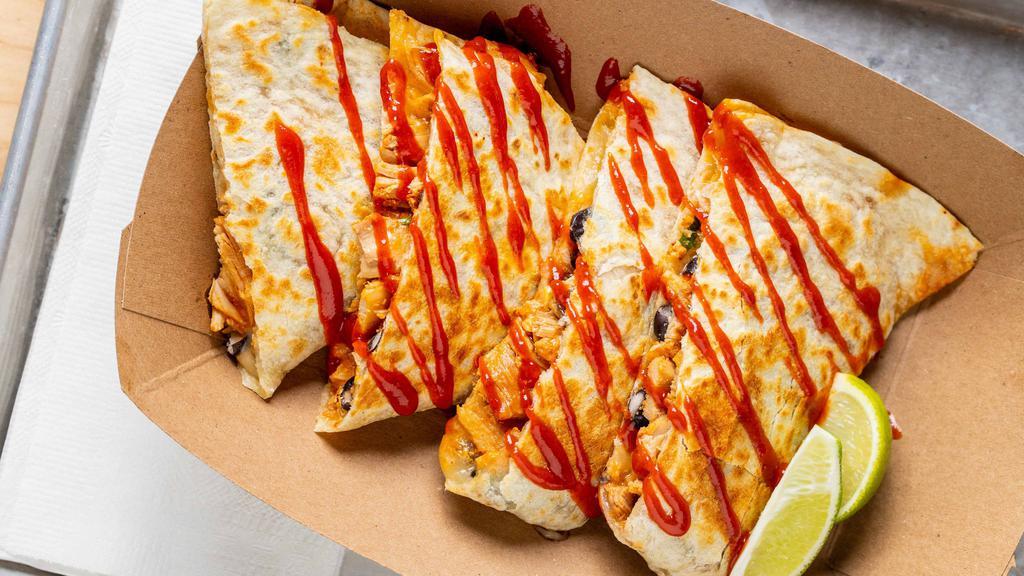 Quesadilla · Your choice of protein, shredded cheese, black bean corn salsa, Yumbii chili sauce, and side of chipotle sour cream.
