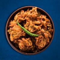 Golden Onion Fritters · Thinly sliced onions dipped in gram flour batter and deep-fried till golden and crisp. Serve...