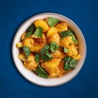 Potato & Cauliflower  (Vegan) · Peas and potatoes, simmered to perfection in an onion, tomato and Indian masala curry.