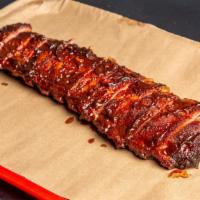 Baby Back Ribs · All-natural pork ribs smoked with sauce.