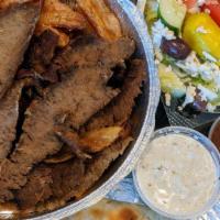 Lamb Plate · Slices of lamb served with Greek potatoes, small Greek salad, and pita bread.