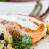 Salmon Fillet · Grilled, topped with a lemon caper sauce served with spinach leek rice, and broccoli.