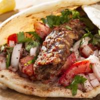 Kabab Sandwich · Made with ground lamb tomatoes and onions and Ole Baba's special sauce.  Photo does not repr...