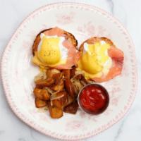 Eggs Benedict · Toasted English muffins topped with poached eggs, Canadian bacon, and hollandaise sauce, ser...
