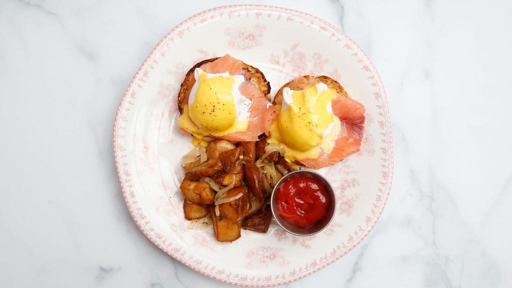Eggs Benedict · Toasted English muffins topped with poached eggs, Canadian bacon, and hollandaise sauce, served with roasted potatoes.