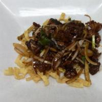 Mongolian Beef · Beef quickly cooked with onions, green onions and fried noodle in sweet dry sauce.