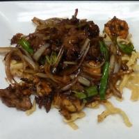 Mongolian Triple · Triple quickly cooked with onions, green onions and fried noodle in sweet dry sauce.