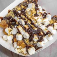 Campfire Churros · 5 pieces cinnamon churros. Topped with chocolate drizzle, gram crackers, roasted  marshmallow.