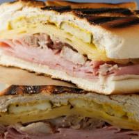 Cuban Sandwich · Cuban bread, ham, roasted pork, and Swiss cheese.