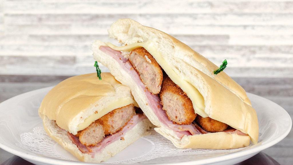 Croquette Sandwich · Croquettes, ham, cheese, and Cuban bread.
