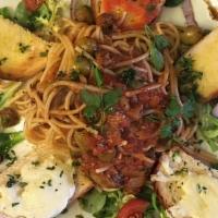 Spaghetti Puttanesca · Spaghetti with marinara, olives, capers, garlic, and anchovies, and topped with fresh Parmes...