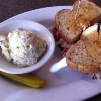Reuben · Corned beef and pastrami steamed and piled high with sauerkraut, Swiss and Russian dressing