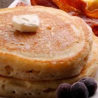 Pancakes · Three golden buttermilk pancakes served with butter and syrup