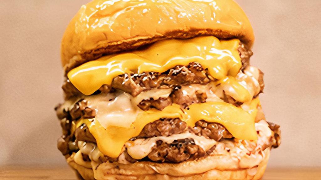 2.2 Burger · Four 4oz beef patties with yellow and white american cheese.
