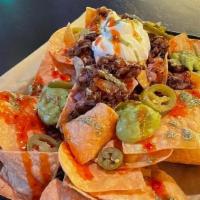 Loaded Nachos! · House made fried to order nachos with guacamole, sour cream, beef and some hot peppers!