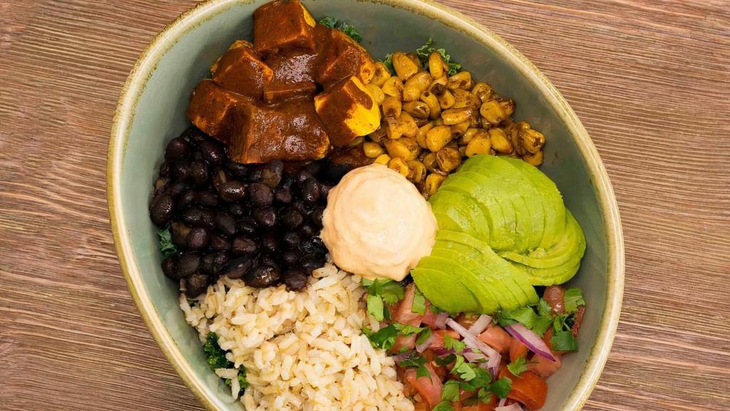 Warm Tex-Mex Bowl · Brown rice, seasoned black beans, roasted corn, spiced roasted tofu, avocado, pico de gallo, kale and sriracha mayo.