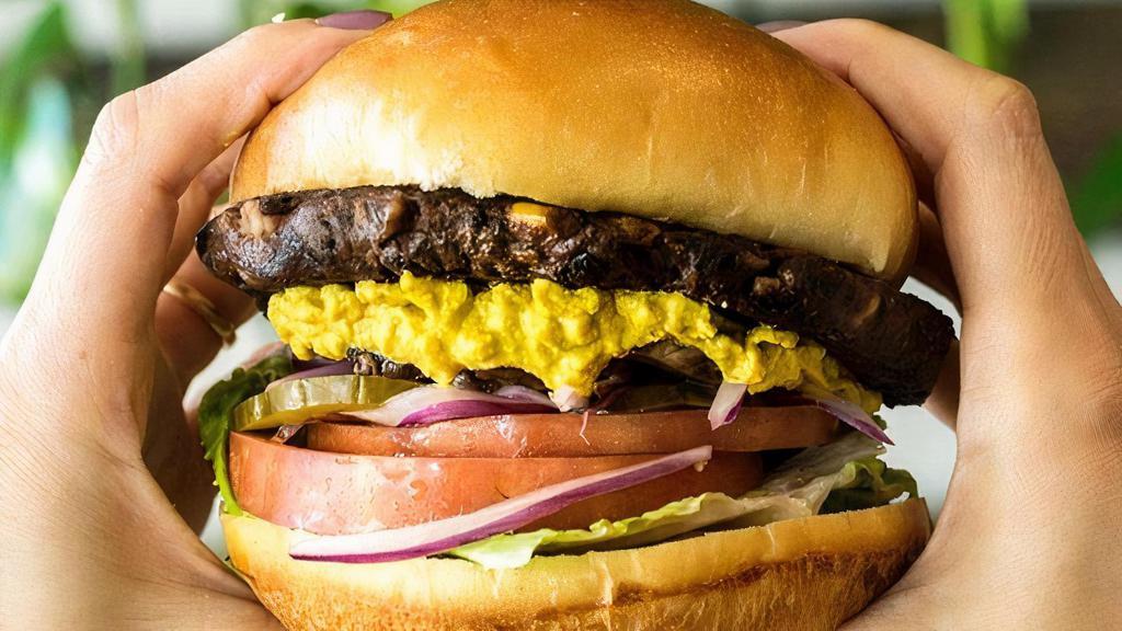 Southwest Black Bean Burger · Black bean and corn patty, romaine lettuce, tomato, red onions, pickles, sauteed mushrooms and homemade raw cashew cheese sauce on a bun. Served with oven roasted potatoes, salad, rice or black beans.