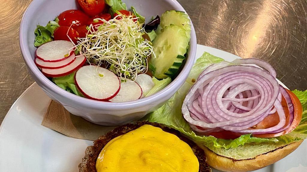 Impossible Burger · Impossible food patty, romaine, lettuce, tomato, red onion and vegan melted cheese on a bun. Served with oven roasted potatoes, salad, rice or black beans.