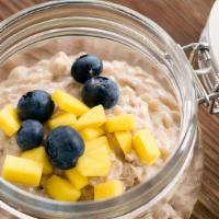 Coconut Rice Pudding (Gf) · Homemade coconut milk rice pudding, topped with fresh mango and blueberries.