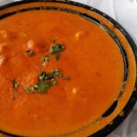 Butter Chicken · Chicken pieces roasted on a clay oven, folded into a rich sweet creamy tomato sauce with nut...