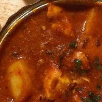 Chicken Vindaloo · Boneless chicken and potatoes marinated in vinegar hot peppers and spices cooked over low he...