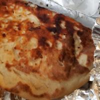 Garlic Naan · Flat leavened bread baked with garlic in tandoor vertical clay oven.