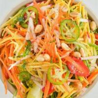 Spicy Mango Salad · Greens, cherry tomatoes, jalapenos, cucumber, carrots, cilantro, radishes, and toasted cocon...