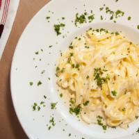 Pasta Alfredo · Rich, Creamy and Cheesy pan made to order.