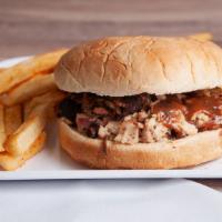 Jerk Chicken Sandwich · Pulled jerk chicken on a toasted bun topped with onion and BBQ sauce. Served with fries.