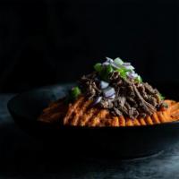 Clean Eatz Nachos · Sweet potato “fries” topped with shredded beef, guacamole, salsa, green peppers and red onio...