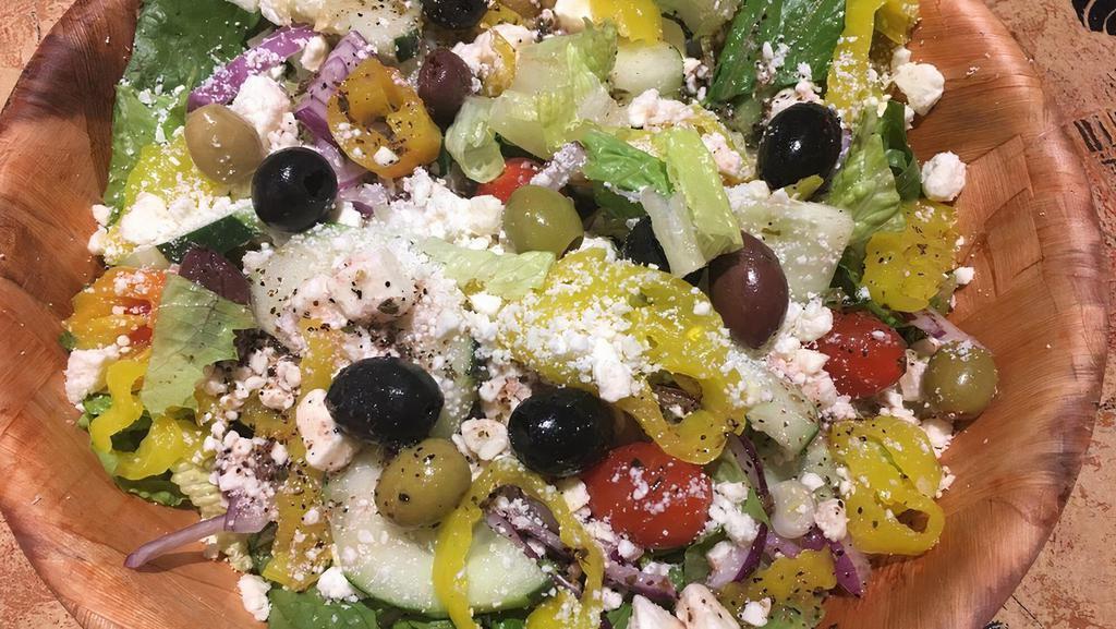 Greek Artichoke Salad · Mixed greens with marinated artichoke hearts, tomatoes, cucumbers, banana peppers, red onions, kalamata and green olives topped with feta cheese. Served with our Italian vinaigrette.