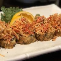 B. Roll Deluxe · Salmon, scallion, and cream cheese deep fried top with spicy crab, onions, scallion jalapeno...