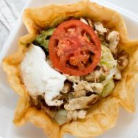 Taco Salad · Crispy taco salad bowl filled with your choice of ground beef or shredded chicken, topped wi...